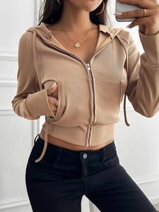 Detailed shot of khaki ribbed knit zip-up hoodie featuring drawstring hem and side pockets