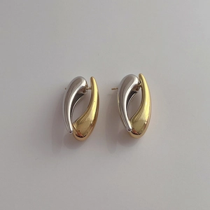 Detailed top view of gold and silver tone teardrop earrings with a smooth polished finish
