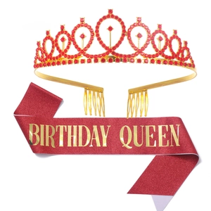 Detail view of a gold-red tiara and red glitter sash with Birthday Queen lettering