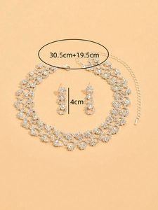 Detailed size view of silver rhinestone jewelry set including necklace and earrings