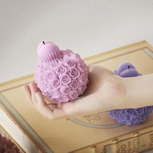 Spherical rose bouquet candle mold with intricate 3D floral textures and wax wick