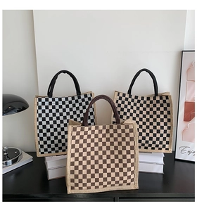 Checkboard pattern linen tote bags in black, coffee, and brown on a desk