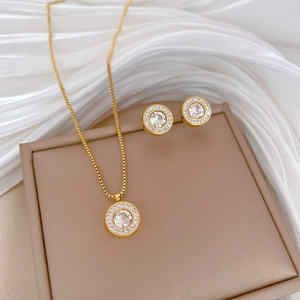 Close-up of gold-plated titanium steel necklace and earrings set with zircon accents