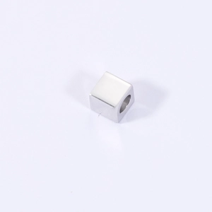 Macro shot of a 4mm polished stainless steel cube bead with center hole for jewelry making