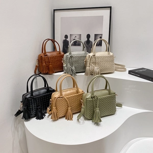 Hand-woven crossbody tote bag in multiple colors with tassels and dual handles