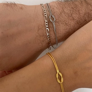 Minimalist gold and silver snake chain knot bracelets for couples on wrists