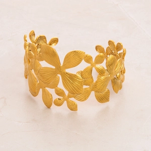 Detailed close-up of adjustable gold plated stainless steel bracelet with floral petals