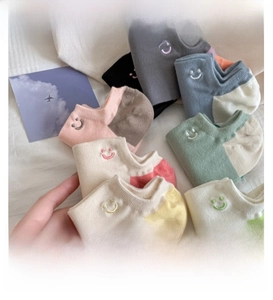 Close-up of colorful cotton boat socks with vibrant smile embroidery details