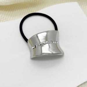 Detailed close-up of a smooth silver alloy hair cuff with sparkling inlaid rhinestones