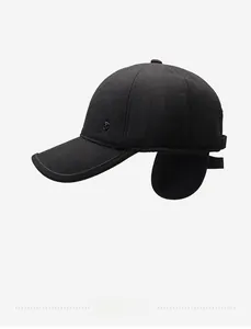 Detail of winter baseball cap with earflaps and metallic shield emblem on the side