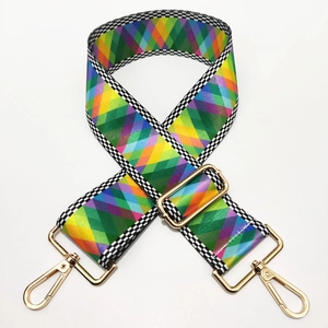 Detail of adjustable rainbow diamond pattern bag strap with gold metal lobster clasps