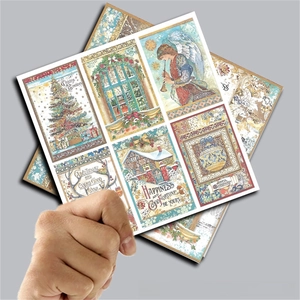 Close-up of vintage Christmas patterned papers featuring angels and winter villages
