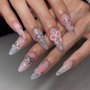 3D bow stiletto press-on nails with pink gradient, pearls and star accents