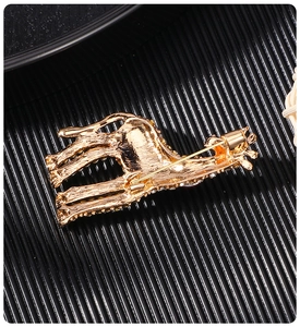 Detailed back view of a golden giraffe brooch showing the alloy structure and pin clasp