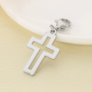 Detailed close-up of a polished stainless steel hollow cross pendant with lobster clasp