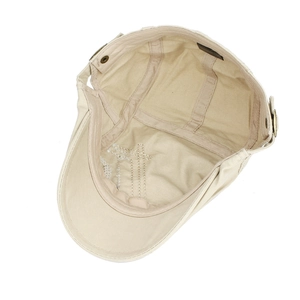 Inside view of beige cotton flat cap showing sweatband and high-quality stitching