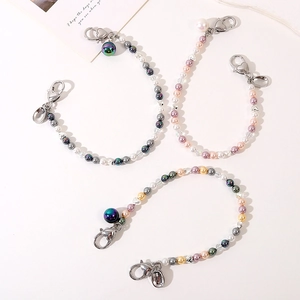 Three beaded charms for bags and phones featuring pearls and colorful metallic heart beads