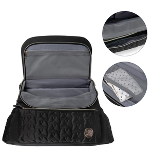 Detail view of black waterproof quilted diaper bag with gold zipper and mesh interior pocket