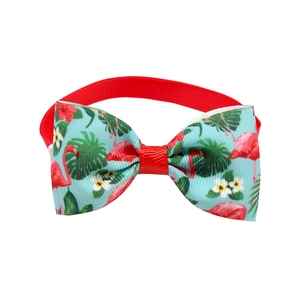 Detail of red polyester pet bowtie with tropical flamingo and green leaf patterns