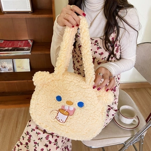 Detailed view of cute lamb wool bear tote bag with embroidery in a cozy indoor setting