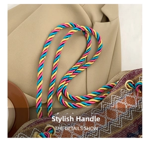Close-up of three-color woven spiral handle and geometric pattern on ethnic tote bag