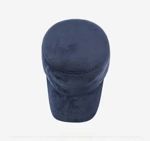 Top down view of a navy blue corduroy flat cap with soft texture and metal button detail
