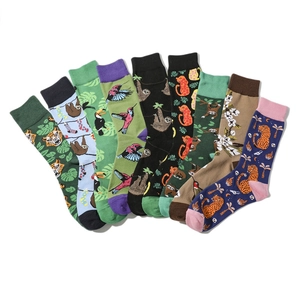 Flat lay fan arrangement of colorful cartoon crew socks featuring leopard and bird prints
