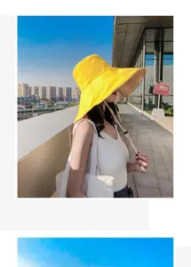 Detail of yellow wide brim sun hat with adjustable chin strap and breathable fabric