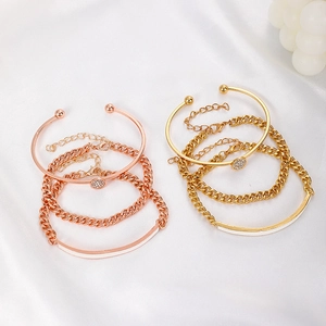 Detail of adjustable gold and rose gold curb chains with pave zircon stones on white silk