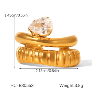 Detail of gold double-layer ring with pear-cut zircon and vertical groove texture