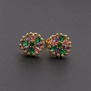 Macro detail of copper 18K gold floral stud earrings with multi-colored zircon stones