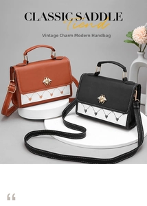 Detail of vintage saddle bags with metal bee accent and heart embroidery patterns