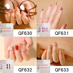Detail showing pink and orange heart nail stickers with floral patterns and gold foil