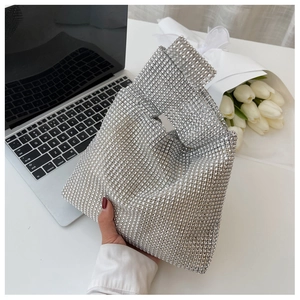 Detail of silver rhinestone handbag with sparkling crystal mesh on a laptop keyboard