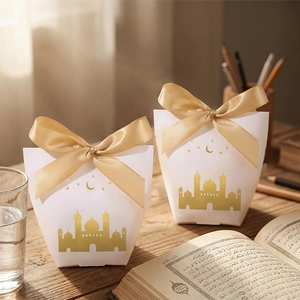 White Islamic gift boxes with gold mosque silhouettes and elegant satin ribbons