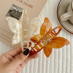 Elegant acetate butterfly hair claws in white mother-of-pearl and amber brown finish