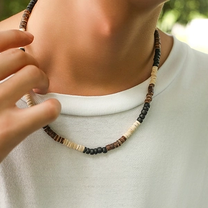 Men's bohemian necklace with mixed brown coconut shell and wooden beads on neck