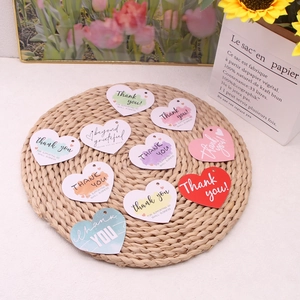 Macro view of assorted heart-shaped paper gift tags with colorful watercolor designs