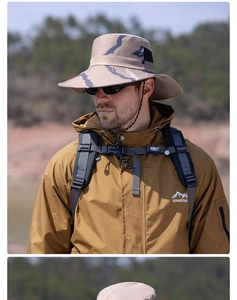 Detail of wide-brim camouflage sun hat with adjustable cord worn in outdoor setting