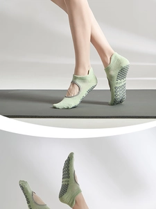 Detail of light green yoga socks with breathable mesh, backless design and anti-slip grips