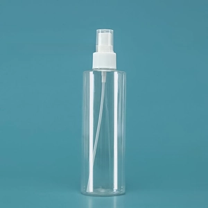 Macro detail of a clear plastic perfume spray bottle with a white nozzle and transparent cap