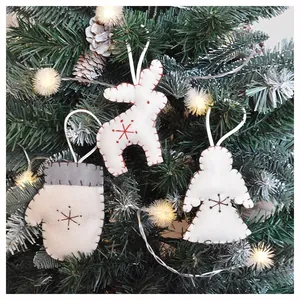 Felt Christmas ornaments including reindeer and angel hanging on a festive tree branch