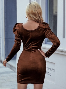 Macro detail of the deep U-shaped open back design on a brown velvet mini dress