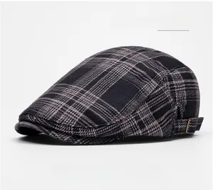 Detail of navy blue plaid flat cap showing wool texture and metal side buckle