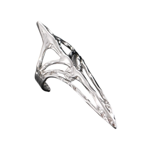 Macro detail of silver zircon-studded fingernail ring with liquid metal texture