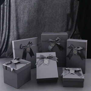 Elegant black square kraft paper gift boxes with silk ribbons for luxury packaging