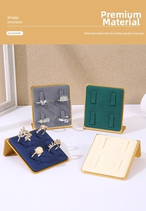 Detail of gold metal ring display stands with four slots and colorful velvet cushions