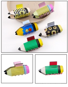 Detail of colorful pencil hair clips with flower and smile patterns on ceramic plate