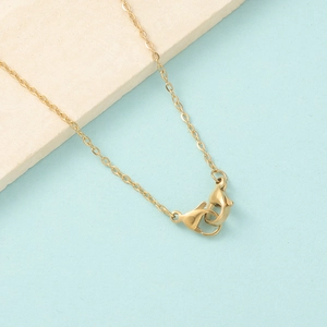 Detail of gold stainless steel link chain featuring secure dual lobster claw clasps