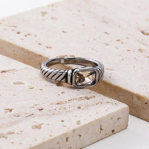 Macro shot of rectangular champagne gemstone with vintage cable pattern band ring